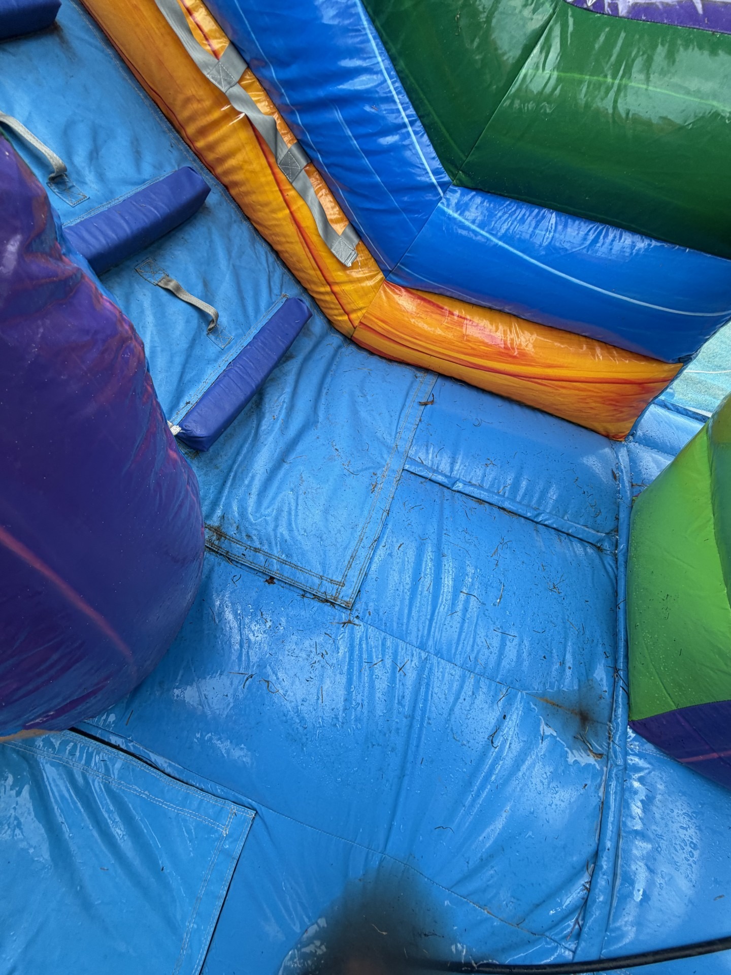 How We Clean Our Bounce Houses | Shindigz Event Rentals Newnan, GA 3 Grass and dirt tracked onto a bounce house floor after a party, before cleaning